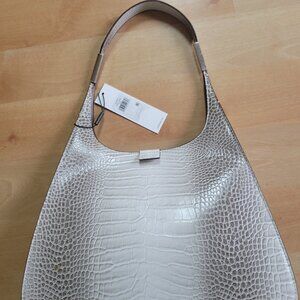 Calvin Klein's Audrey Hobo features a unique silhouette and gorgeous croc-emboss